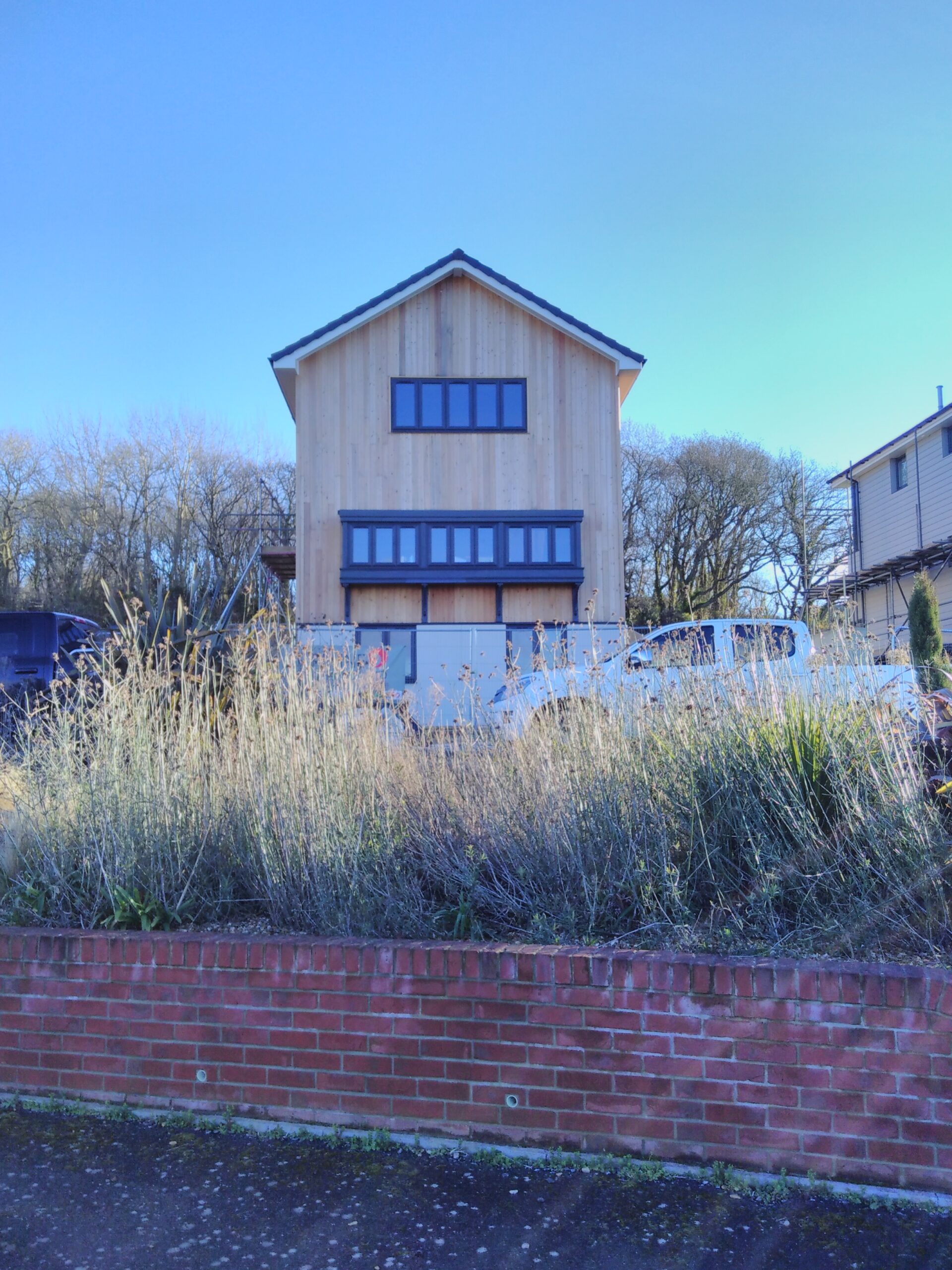 A large house with small windows in rows, standing alone.