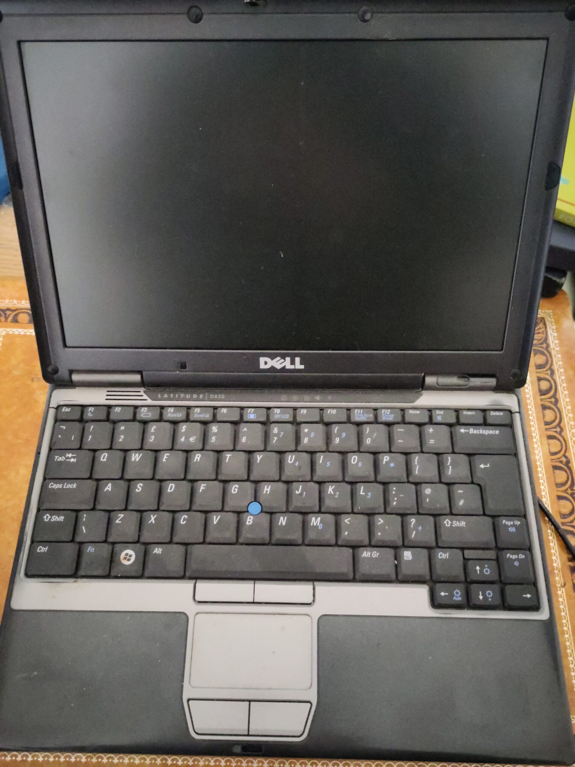 An outmoded Dell laptop, open.