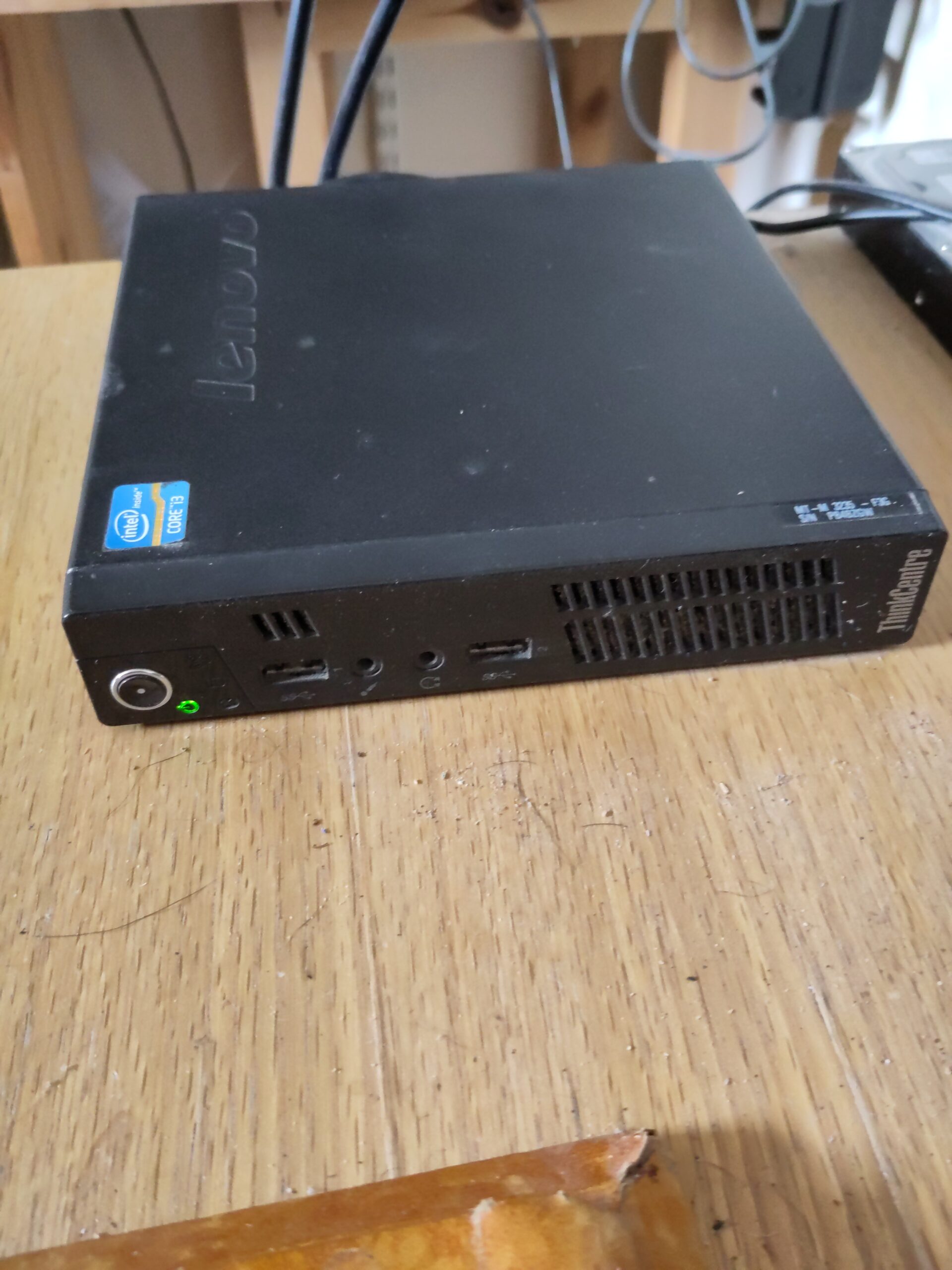 A small desktop computer, labelled "ThinkCentre Tiny".